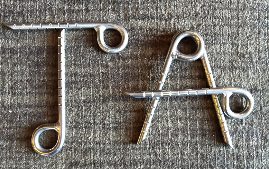 Stainless glue-in bolts arranged to spell TA